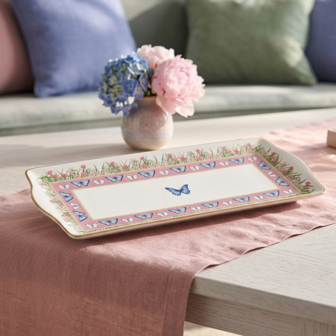 A rectangular ceramic serving platter with a floral and butterfly border, 